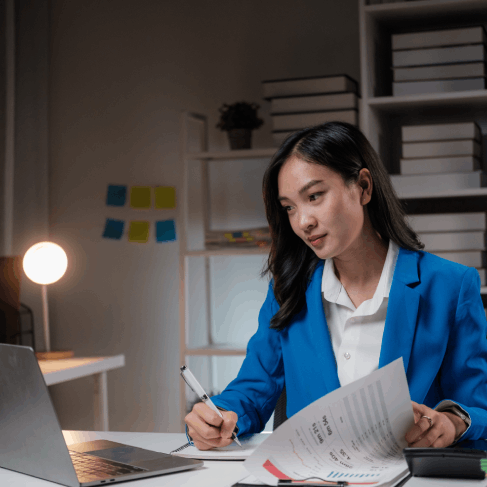 A translator works at a desk with textbooks, providing Haitian Creole Translation Services in Florida for academic documents.