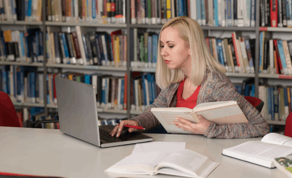 A student reviews a certified thesis translation on a laptop, relying on Translation Services in Hollywood for academic.