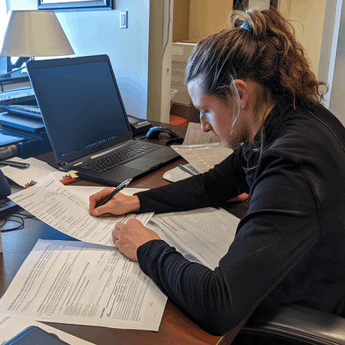 A student checks an academic transcript at a desk, showing Translation Services in Pembroke Pines for academic documents.