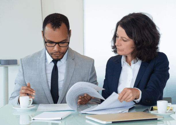 A Florida manager reviews a certified contract with a translator, using Spanish Translation Services in Florida for business.