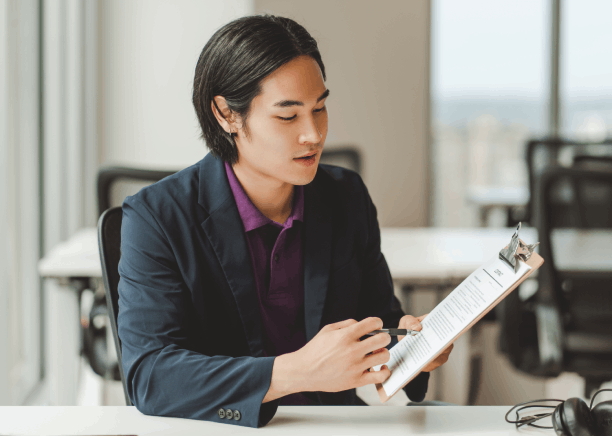 A translator applies a certified stamp to an official document, showing Chinese translation services in Florida.