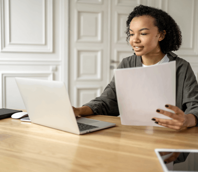 A client edits a French to English contract at a desk, showing French Translation Services in Florida and English.