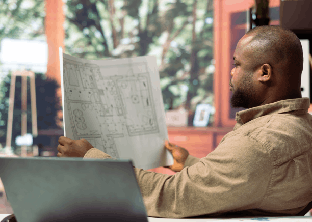 An engineer reviews a user manual alongside Haitian Creole Translation Services in Florida, confirming precise technical.