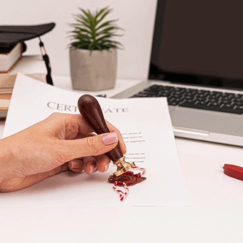 A certified translation stamp is placed on a birth certificate, and French Translation Services in Florida.