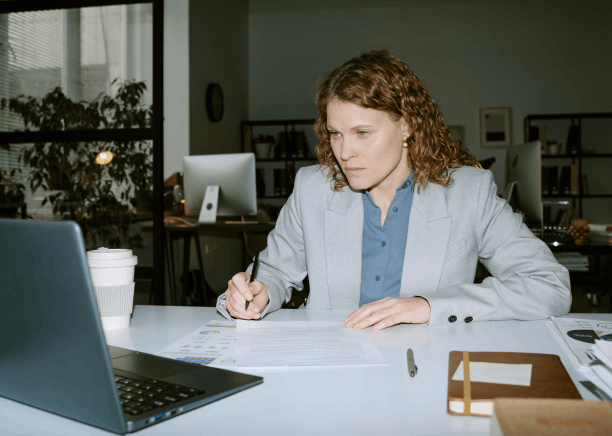 A specialist prepares Translation Services in Hialeah for varied industries, comparing a medical form, invoice and manual.