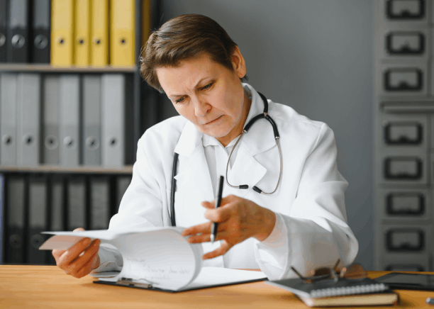 A doctor reviews a discharge summary for Portuguese Translation Services in Florida, supporting accurate translation.