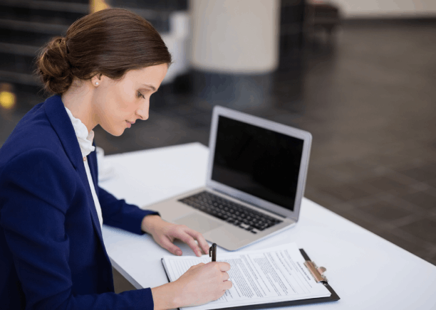The translator checks a certified stamp on a Spanish document for official filing, using Spanish Translation Services.