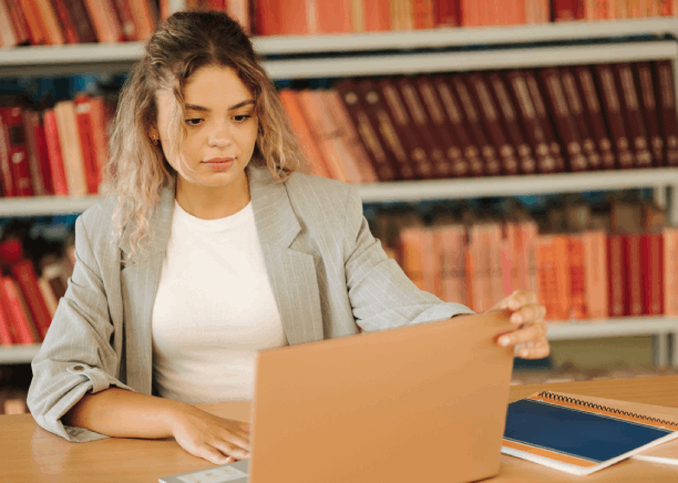 A student using a Spanish transcript beside a laptop, using Spanish Translation Services in Florida for academic purposes.