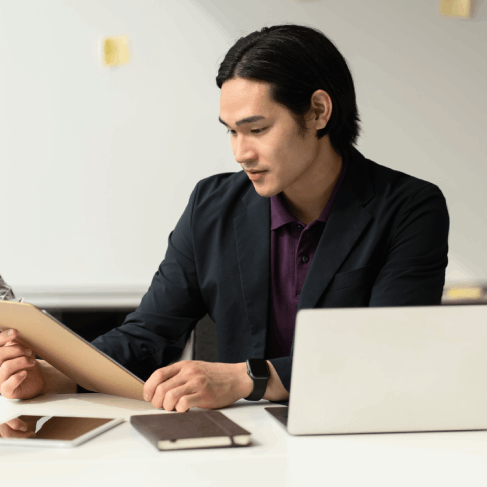 A translator checks software UI strings on a laptop, highlighting Translation Services in Miami for technical.