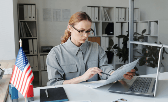 A translator reviews a USCIS birth certificate packet with a checklist, using Translation Services in Hollywood.
